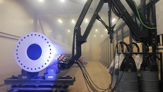 Robotic solution for metallizing wind turbine tower sections in a European production
